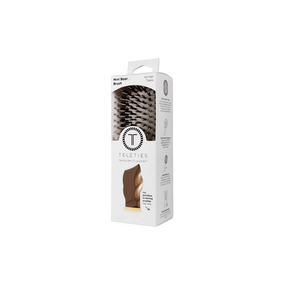 TELETIES Golden Glow mini boar bristle hair brush in its white retail box with a window showing the gold brush

