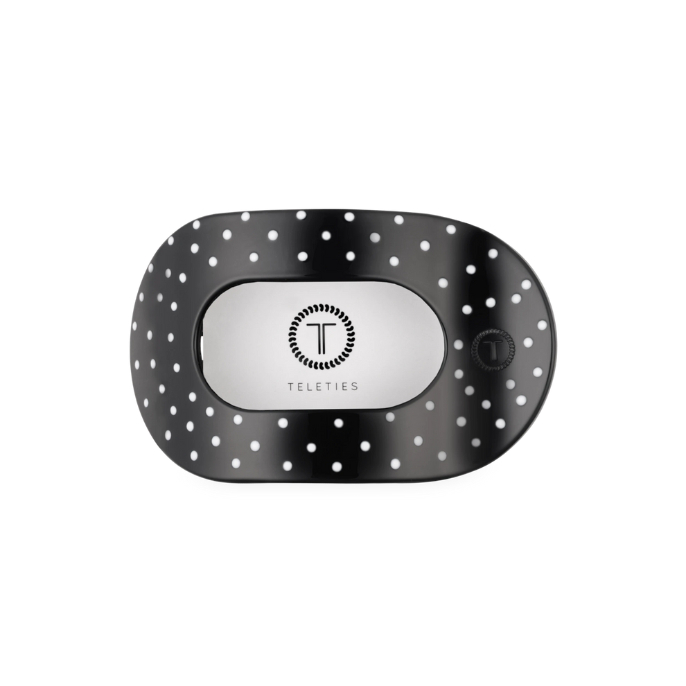 TELETIES medium flat round hair clip in black with white polka dots, designed for comfortable and fashionable wear.
