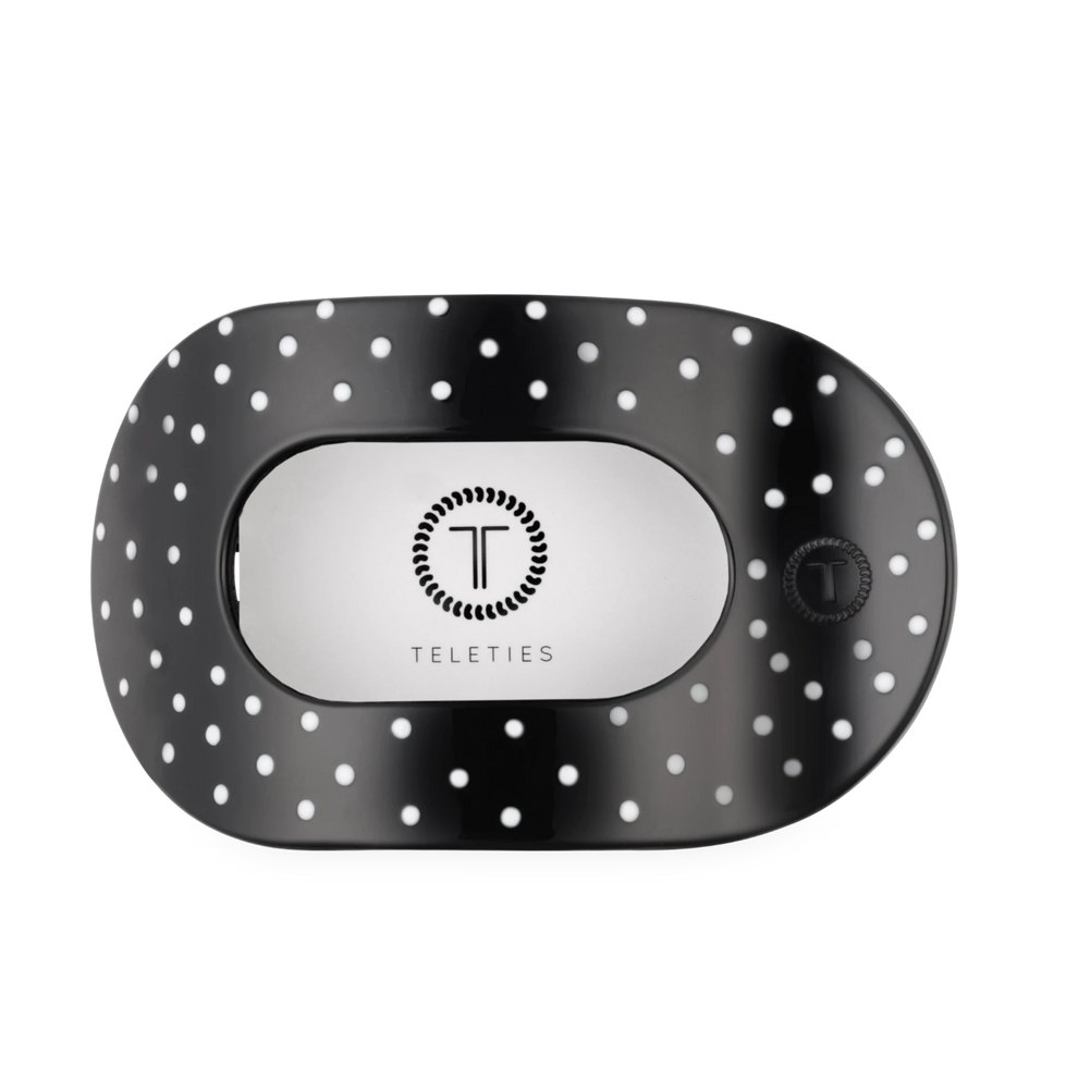 TELETIES large flat round hair clip in black with white polka dots for comfortable wear against headrests.

