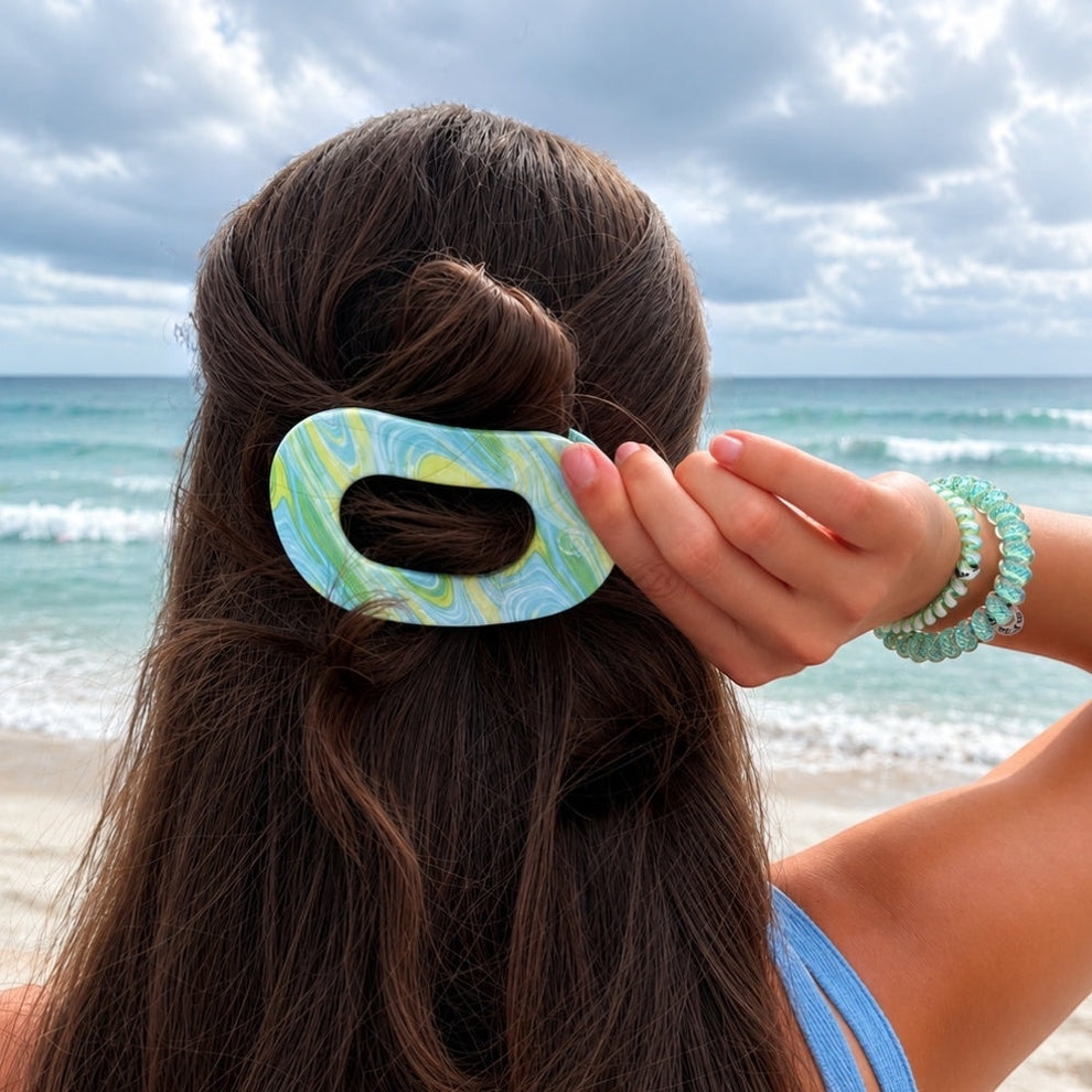 TELETIES By the Sea Shore Medium Flat Round Hair Clip in green and blue marbled pattern.
