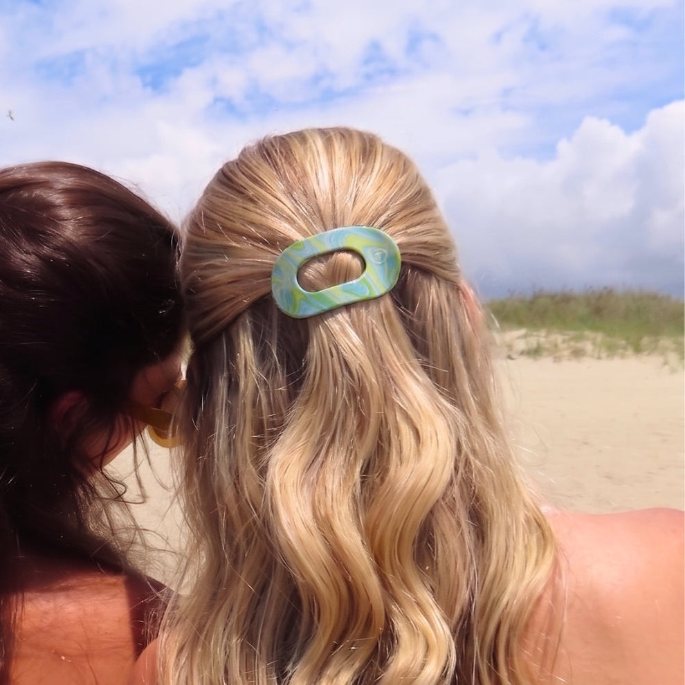 TELETIES By the Sea Shore small flat round hair clip in green and blue marbled pattern.
