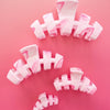 TELETIES Classic Pinch Me! Small Claw Clip in pink marble pattern. Features bendable teeth for a secure hold.

