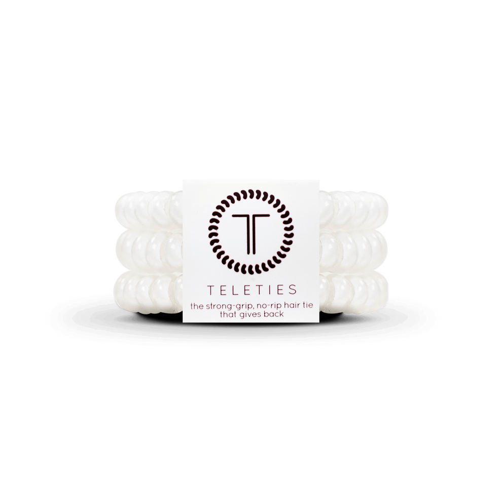 TELETIES Coconut White small hair ties in a pack of three. Spiral design, waterproof, gentle on hair. Double as a bracelet. Shrinks with heat.
