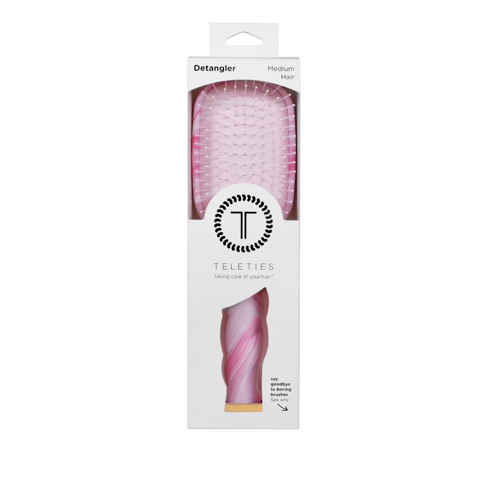 TELETIES Pinch Me detangler brush for medium hair in pink tie-dye with gentle glide bristles and ergonomic coil handle.

