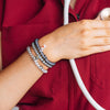 TELETIES Good Hair Rx small spiral hair ties in grey and silver worn as a bracelet by a healthcare worker

