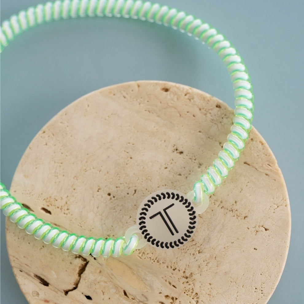 TELETIES By the Sea Shore green spiral headband with no-slip rubber stopper and T logo.
