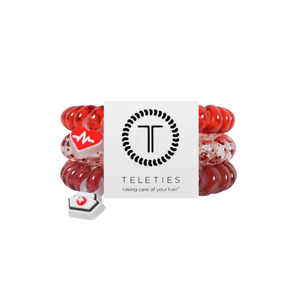 TELETIES Heart and Hustle large hair ties in red with medical-themed charms on a branded display card.

