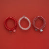 TELETIES Heart and Hustle large spiral hair ties in red and clear with medical-themed charms on a red background
