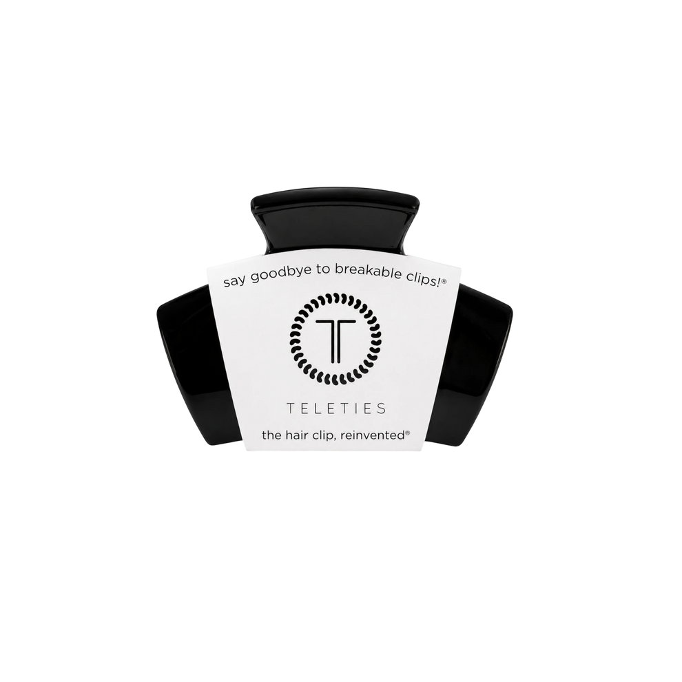 TELETIES classic jet black petite hair claw clip with branded packaging on a black background.
