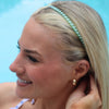 TELETIES Just Keep Swimming Bundle includes a green and white zig-zag headband worn by a blonde woman by the pool.
