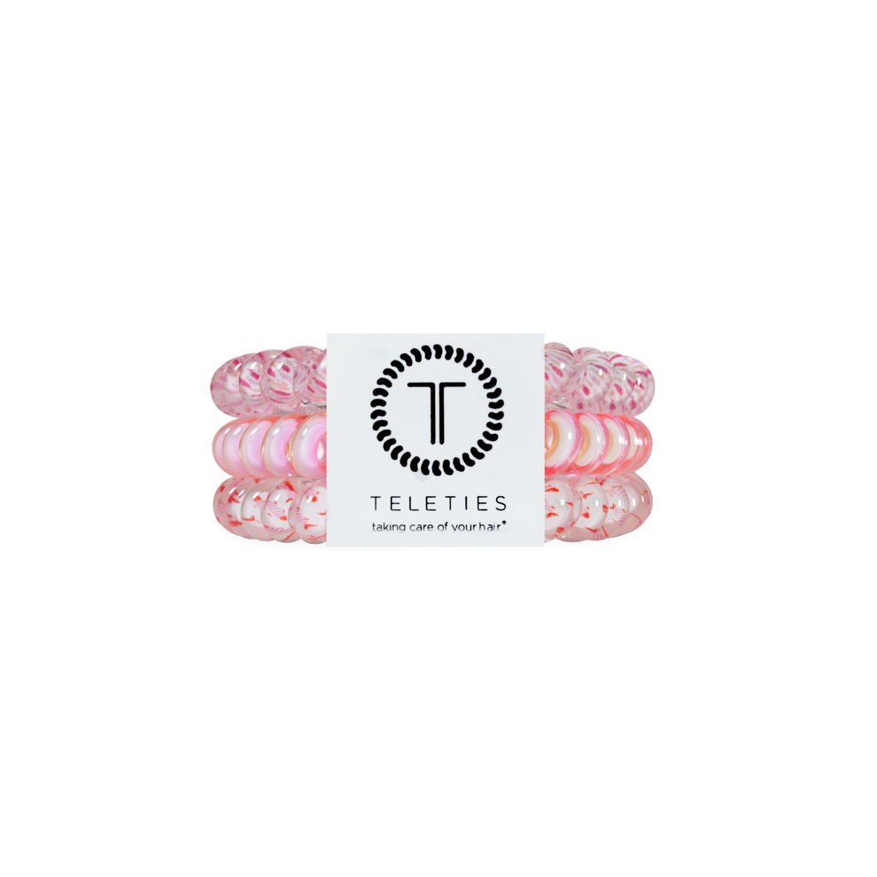 TELETIES Just Keep Swimming small hair ties in pink and white, sold in a pack of three. Spiral design for a strong grip without damage.
