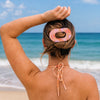 TELETIES Just Keep Swimming large flat oval hair clip in pink and orange marble pattern, holding back blonde hair in a bun.
