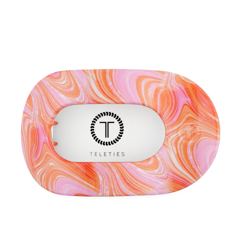 TELETIES Just Keep Swimming large flat round hair clip in pink and orange marble pattern. Features bendable teeth.
