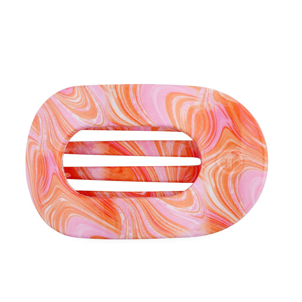 TELETIES Just Keep Swimming large flat round hair clip in pink and orange marble pattern. Bendable teeth.

