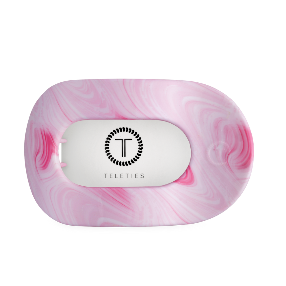 TELETIES large flat round pink hair clip with white center and black logo. Bendable teeth for secure hold.
