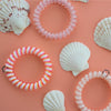 TELETIES large pink and white spiral hair ties, sold in packs of three, gentle on hair, waterproof.
