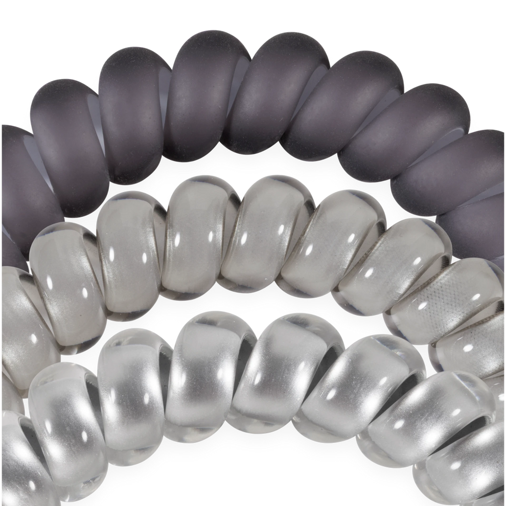 TELETIES Good Hair Rx large spiral hair ties in grey and clear shades, designed for a secure, no-rip hold.
