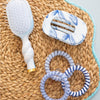 TELETIES blue and white marbled medium flat round hair clip with bendable teeth for a comfortable hold.
