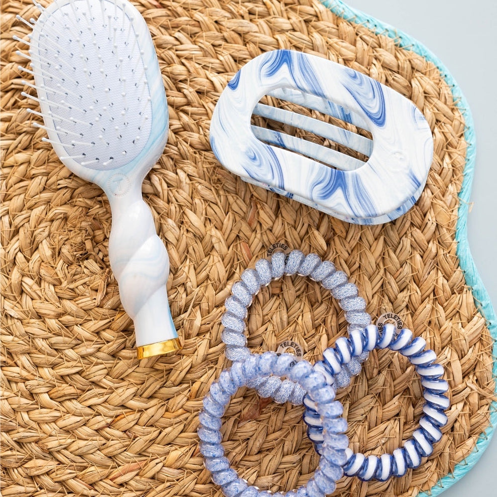 TELETIES blue and white marbled medium flat round hair clip with bendable teeth for a comfortable hold.
