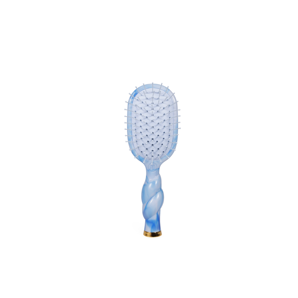 TELETIES mini detangler hair brush with blue tie-dye swirl pattern, gentle glide bristles, and gold accent.
