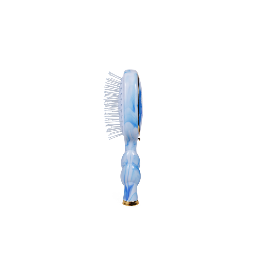 TELETIES mini detangler hair brush with blue and white tie-dye pattern and gold accent
