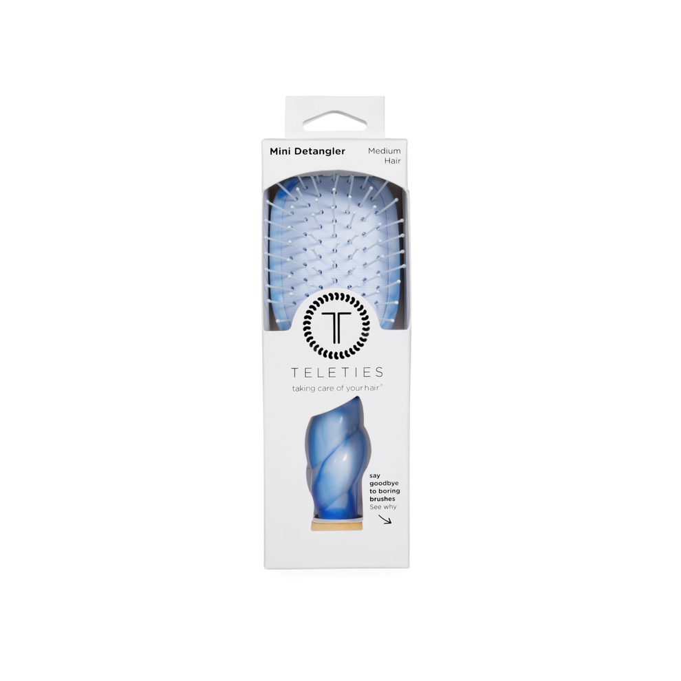 TELETIES Mini Detangler Hair Brush for medium hair in a unique blue tie-dye swirl pattern with built-in mirror and storage.
