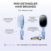 TELETIES blue and white tie-dye mini detangler hair brush with built-in mirror and storage.
