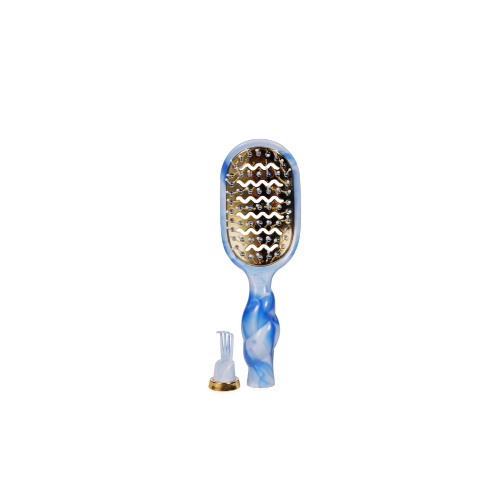 TELETIES mini vented hair brush with blue and white swirl handle and gold vented plate. Includes cleaning tool.
