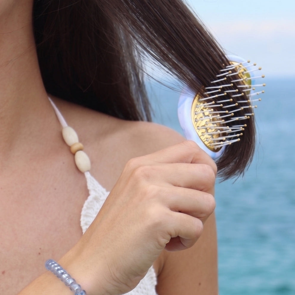 TELETIES Mini Vented Hair Brush with anti-static bristles and gold pins, perfect for travel and quick styling.
