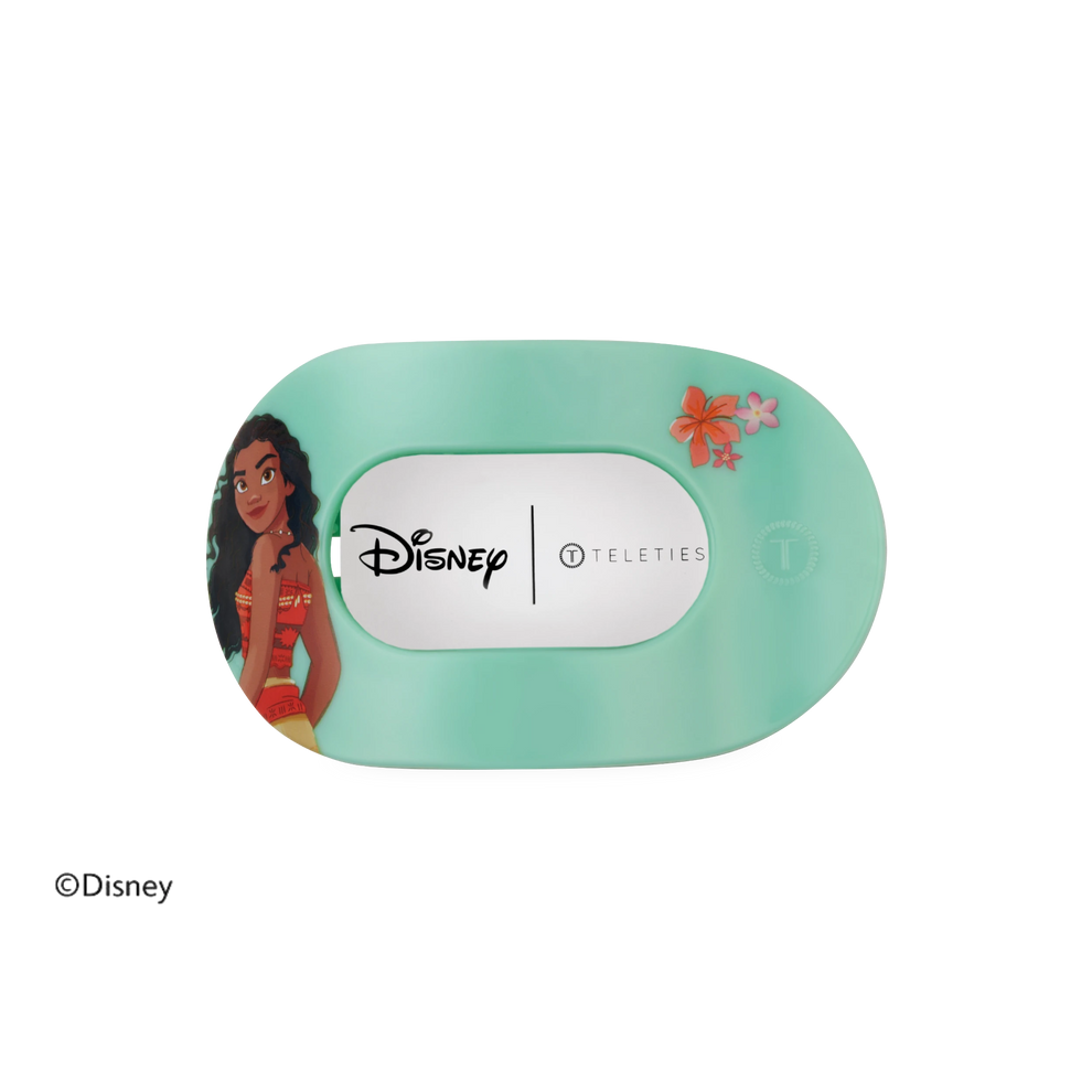 TELETIES Moana medium flat round hair clip in teal with Moana character graphic and floral accents.
