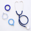 TELETIES On Call large spiral hair ties in blue shades with a matching stethoscope on a white background
