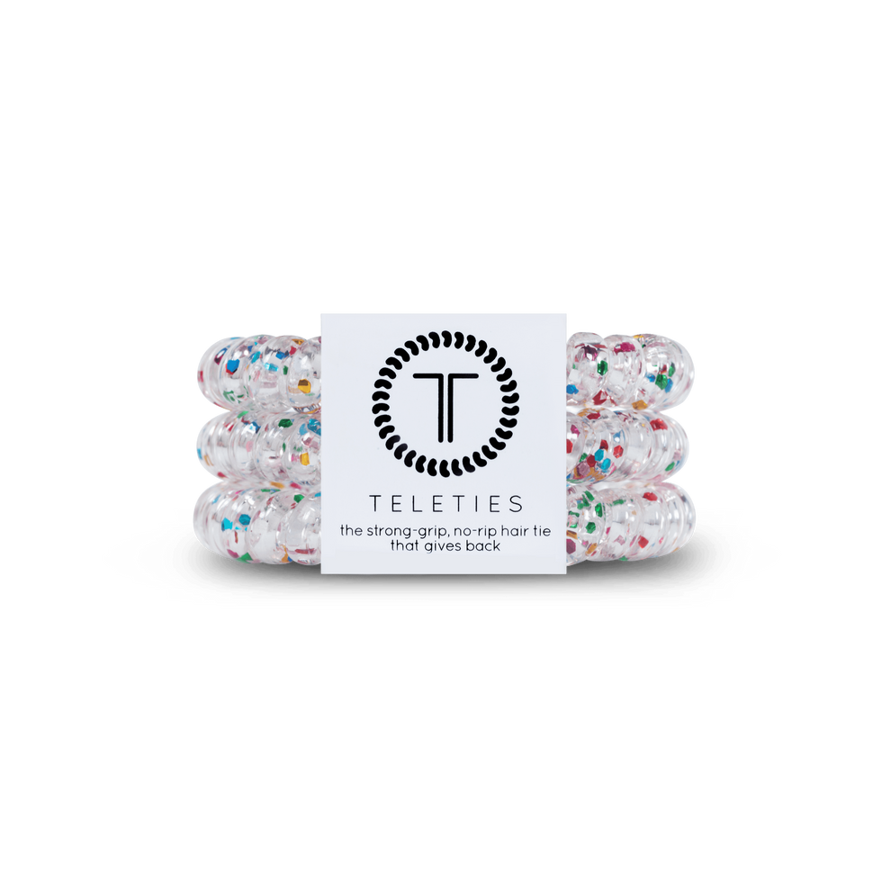 TELETIES Party People small clear hair ties with multicolor confetti, sold in packs of three. Waterproof with not strong grip and no rip design. Double as a bracelet.

