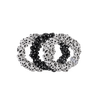 TELETIES small silk scrunchies in a black and white polka dot print, featuring a non-slip inner coil design.
