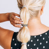 TELETIES small spiral hair ties in black and white polka dot print styled in a bubble ponytail on blonde hair
