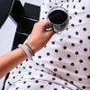 TELETIES polka dot spiral hair ties worn as bracelets on a woman holding a glass of red wine
