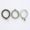 TELETIES Good Hair Rx small spiral hair ties in grey, clear, and silver with medical-themed charms on a white background
