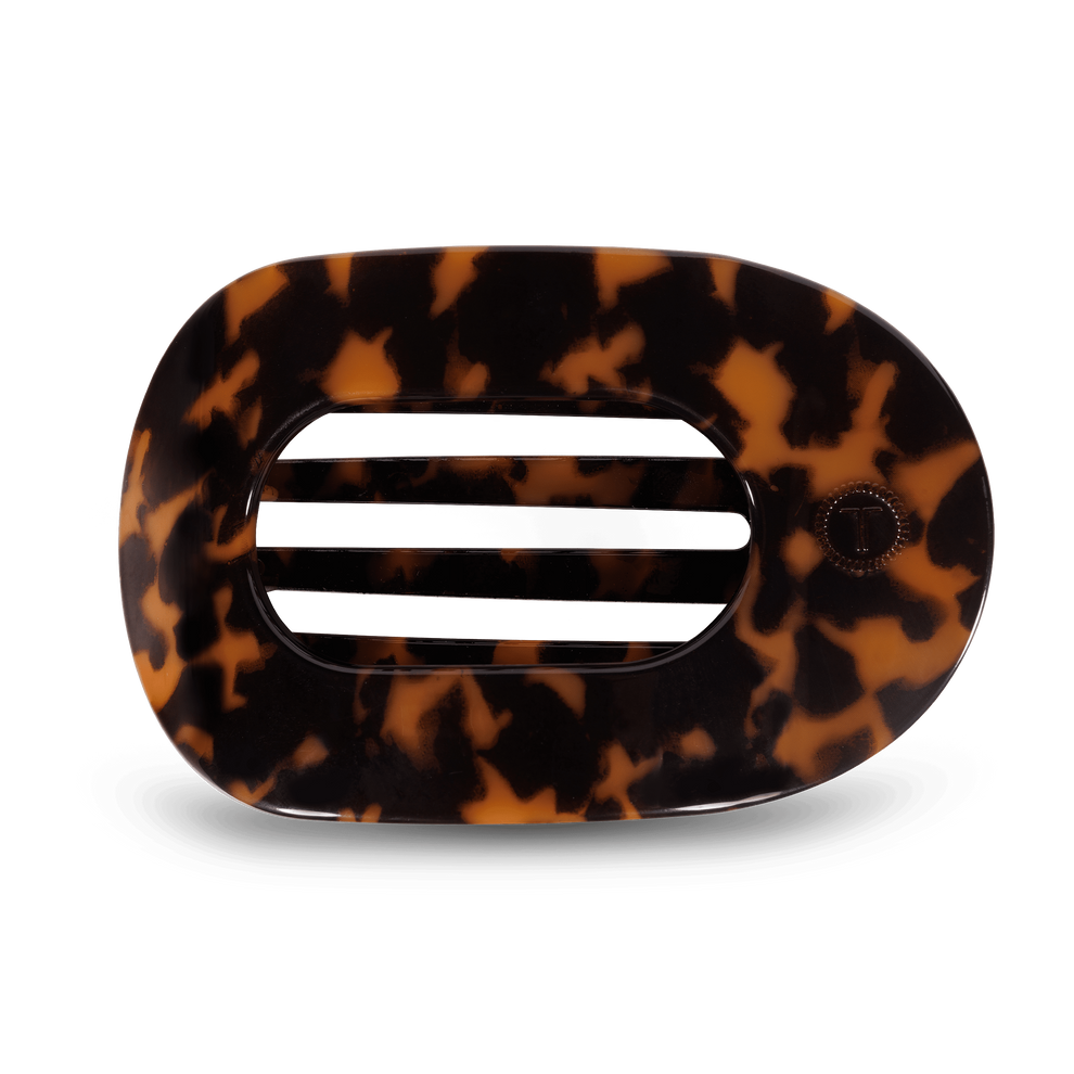 TELETIES Tortoise Large Flat Round Hair Clip, measuring 4.5 inches, with a brown tortoiseshell pattern. Its flexible teeth provide a secure hold, making it nearly unbreakable. The clip is neutral in color, lightweight, and its flat design enhances comfort when laying flat, workouts, and driving.
