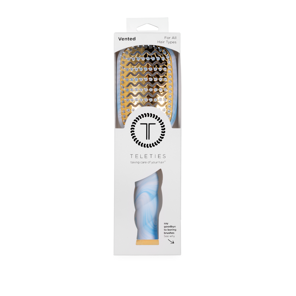 TELETIES blue tie-dye vented hair brush with gold plate and anti-static bristles for faster blowouts.
