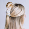 TELETIES medium claw clip in white with black polka dots styled in blonde hair
