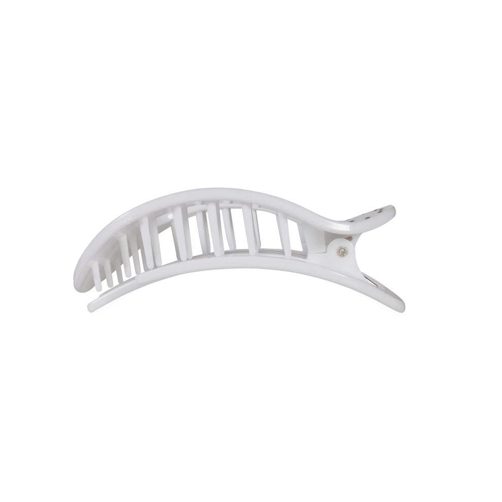 TELETIES white flat round hair clip with black polka dots, designed for comfortable wear while leaning back.
