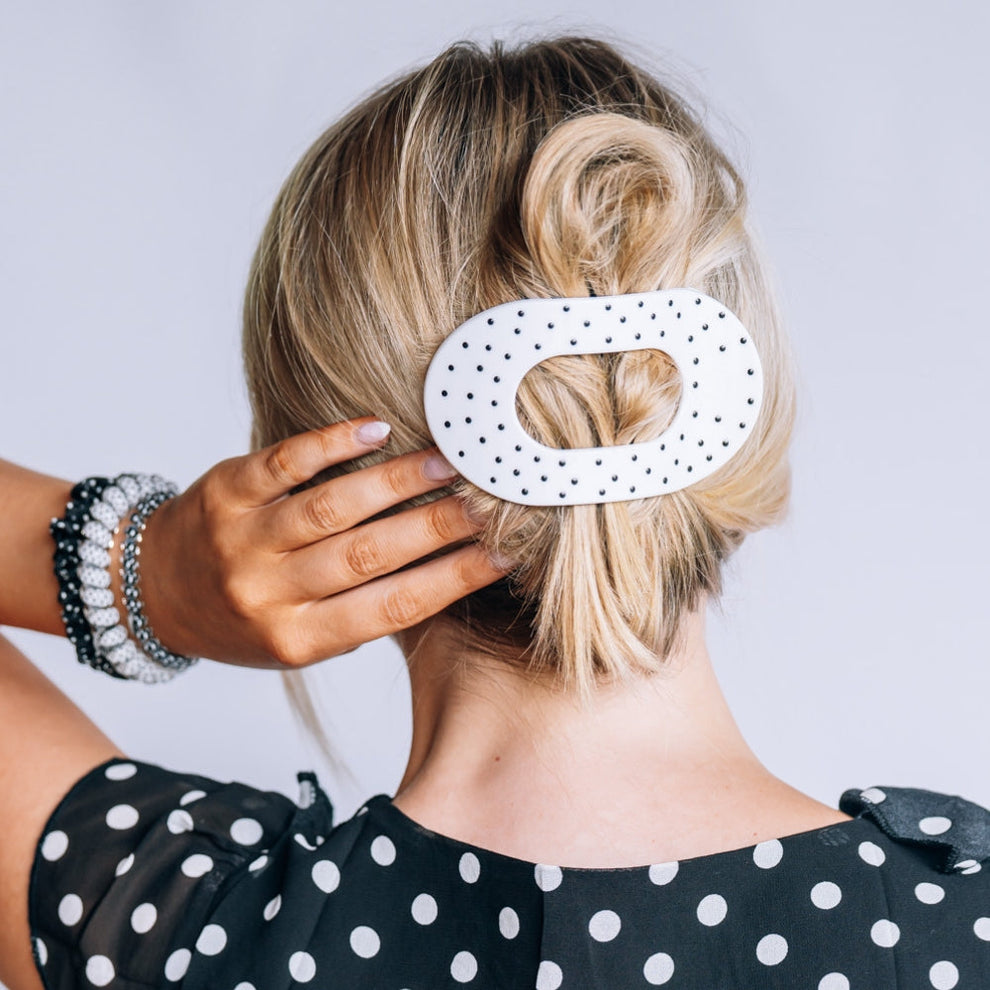 TELETIES large flat round hair clip in white with black polka dots worn in blonde hair
